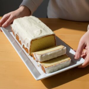 “Keto Lemon Pound Cake sliced with lemon glaze”